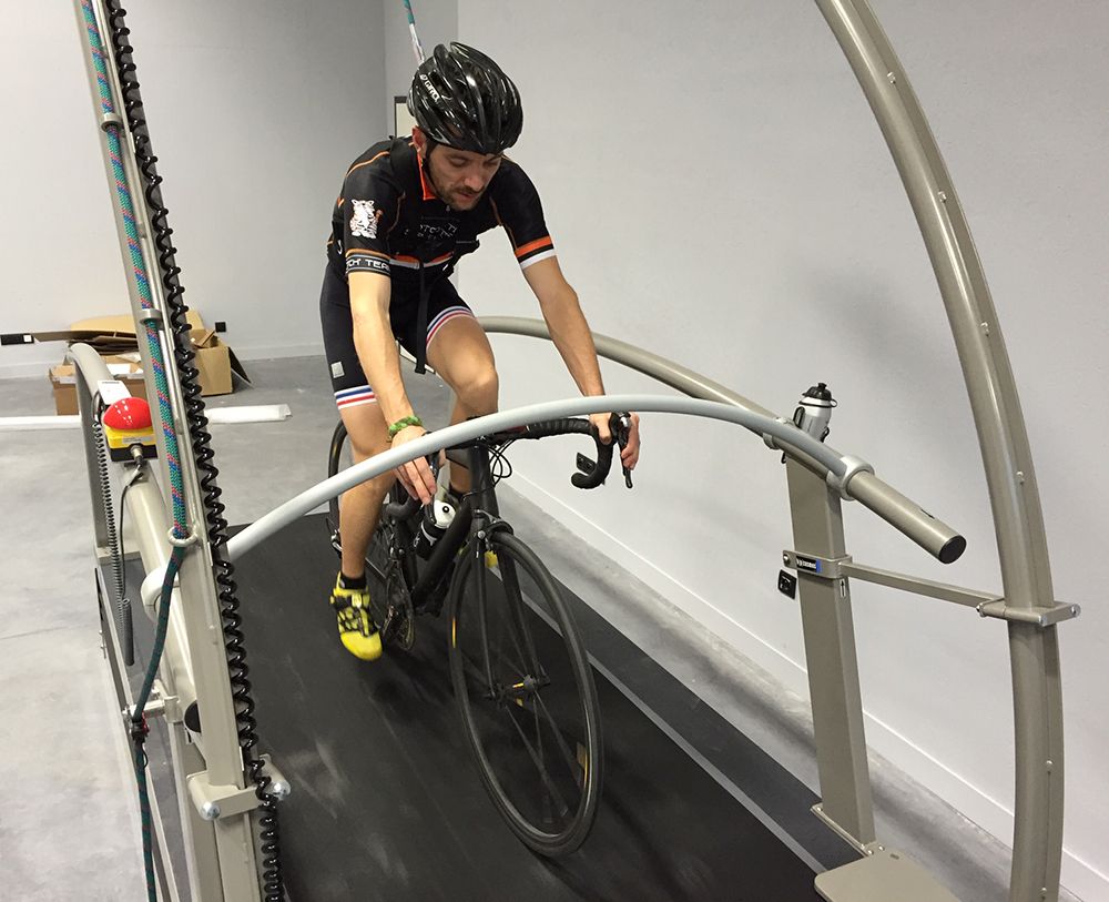 Rider testing a bike on a treadmill test rig
